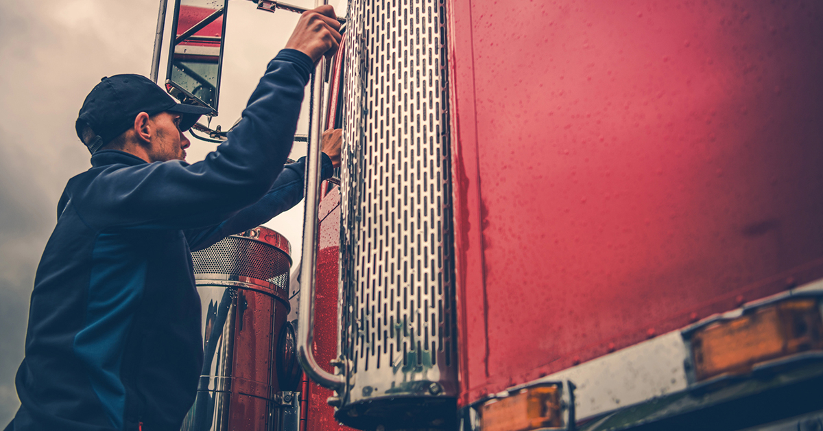 A truck driver getting ready to get into his truck.