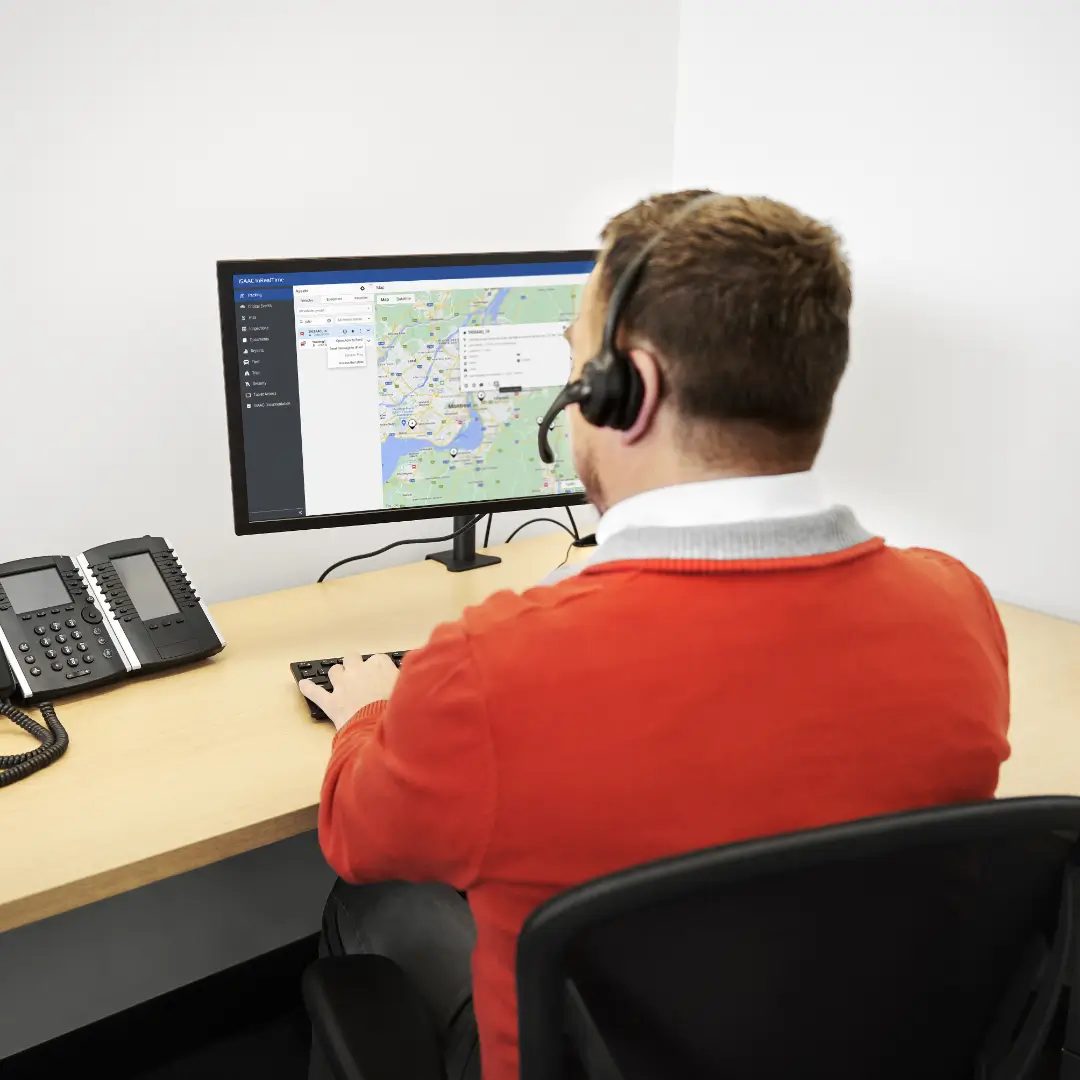 Dispatcher using a computer to monitor fleet activity via the ISAAC platform.