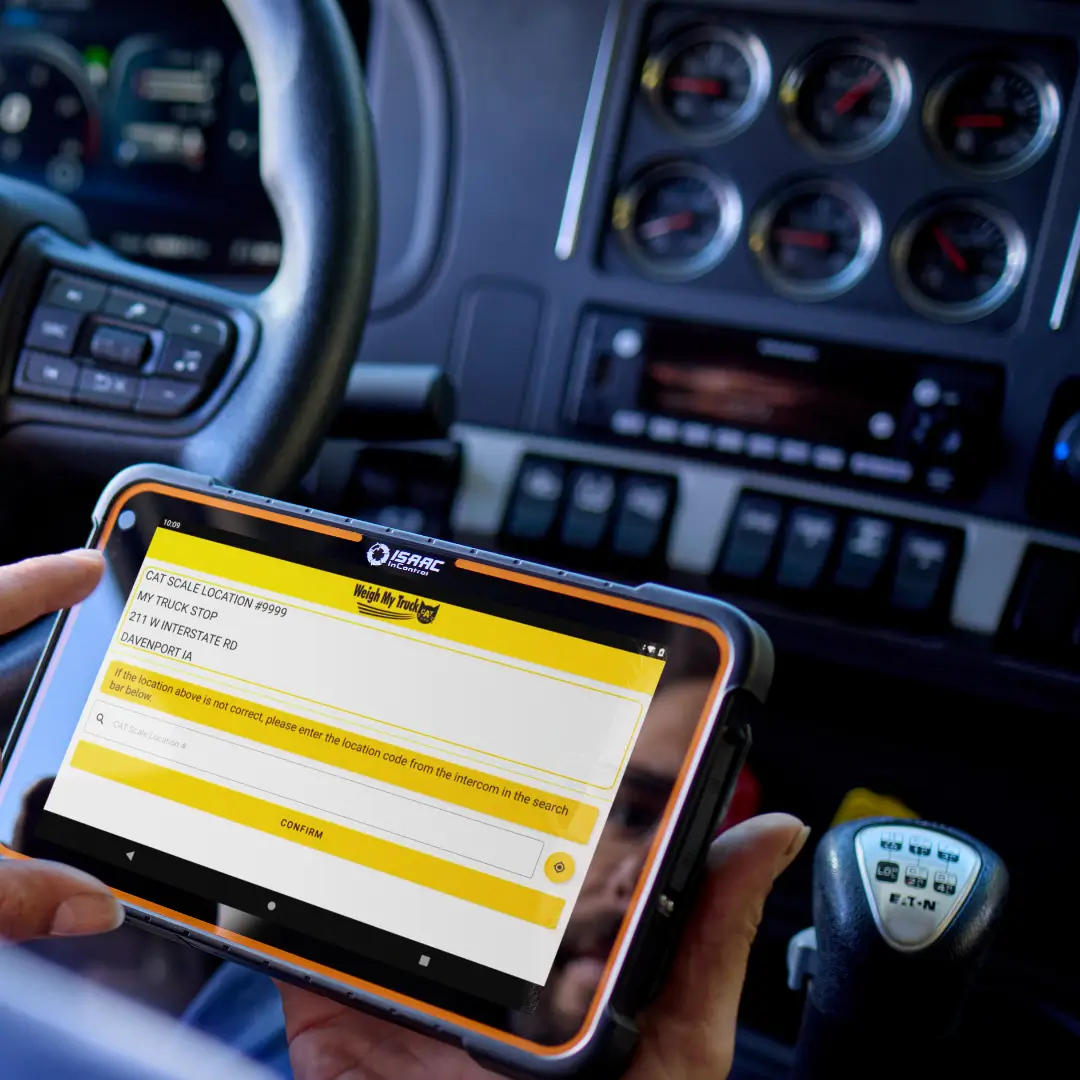 Truck driver using ISAAC platform on a tablet to weigh the truck at a scale.