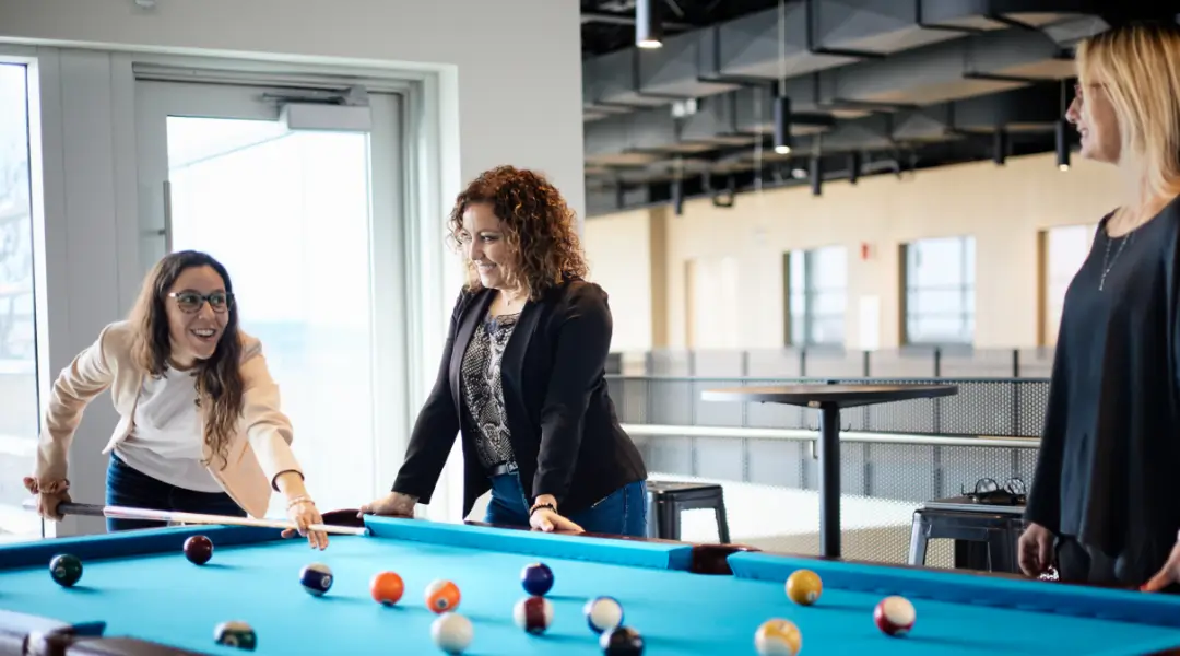 Employees enjoying a game of pool in the recreational area at ISAAC Instruments’ office.