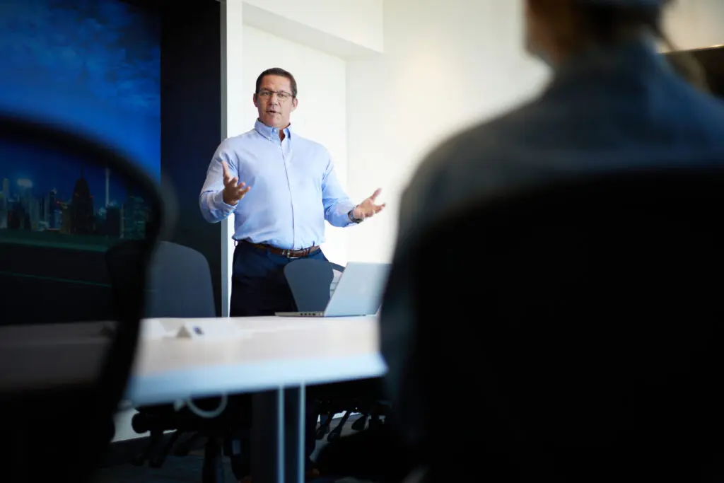 Male consultant giving a presentation in a modern conference room, discussing logistics technology
